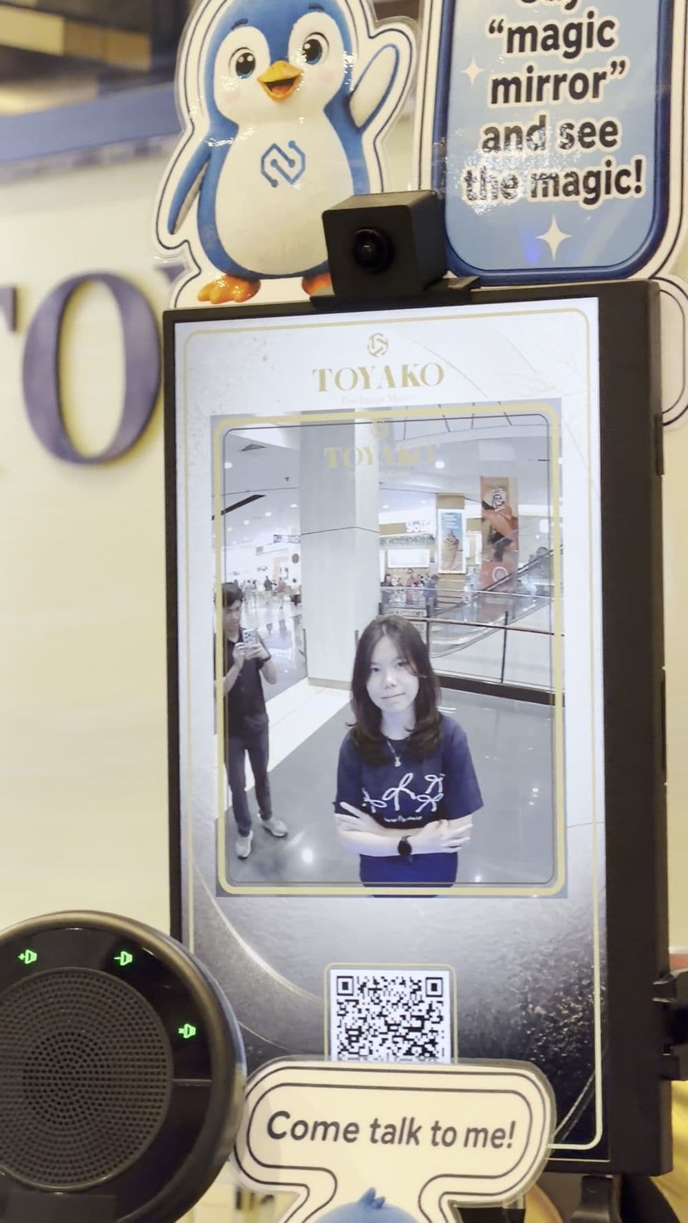 A Magic Mirror hairstyle preview with a QR code, during a test with a tester