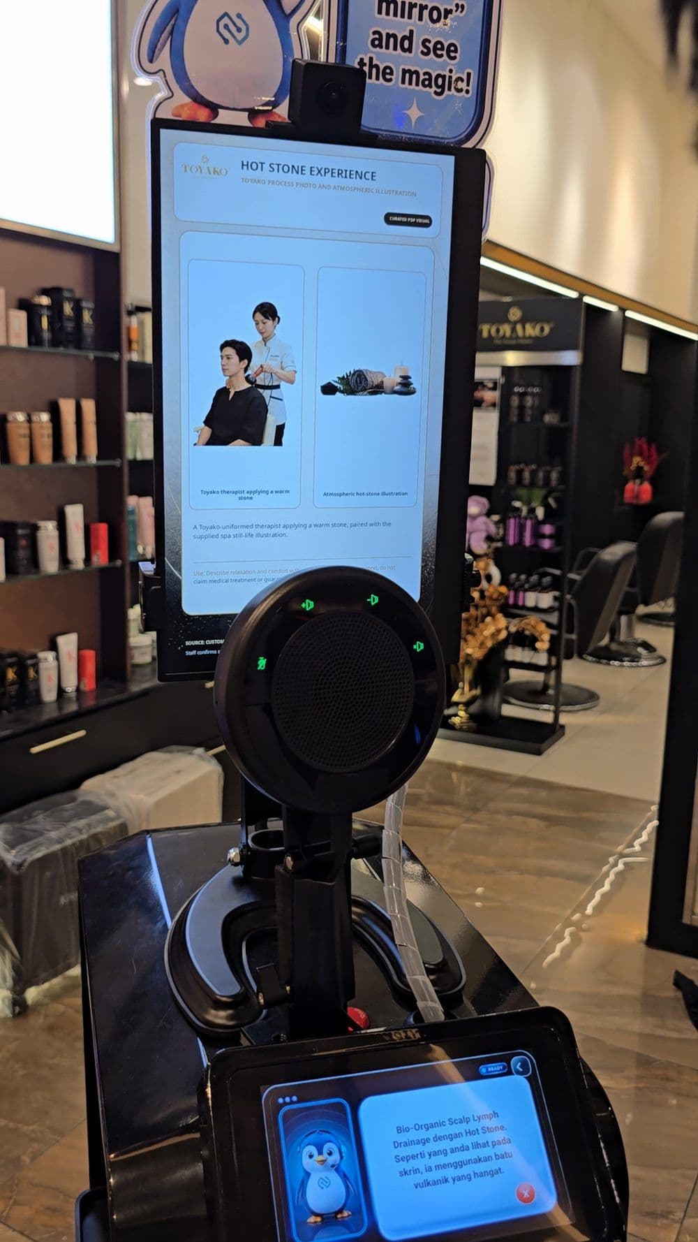 Pip explaining a salon service, with the service on FL1's screen